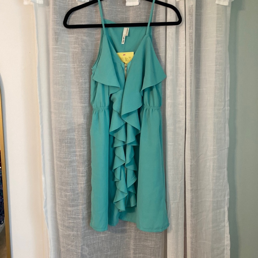 Teal-green dress with ruffle detail and zipper